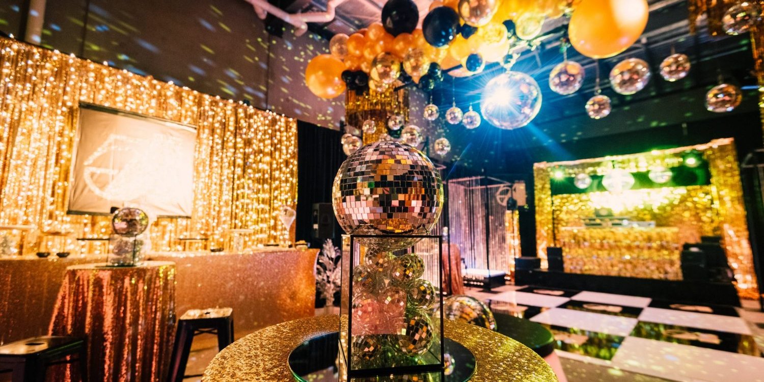 studio 54 themed party with mirror balls and themed props