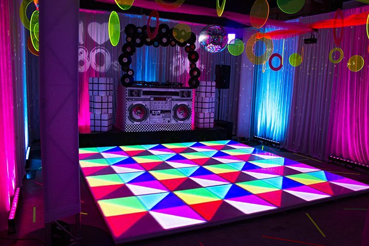 80s themed event illuminated LED dance floor, 80s themed dj booth, fluro discs