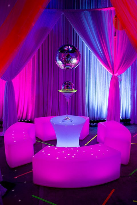 80s themed event illuminated furniture, draping, mirror balls