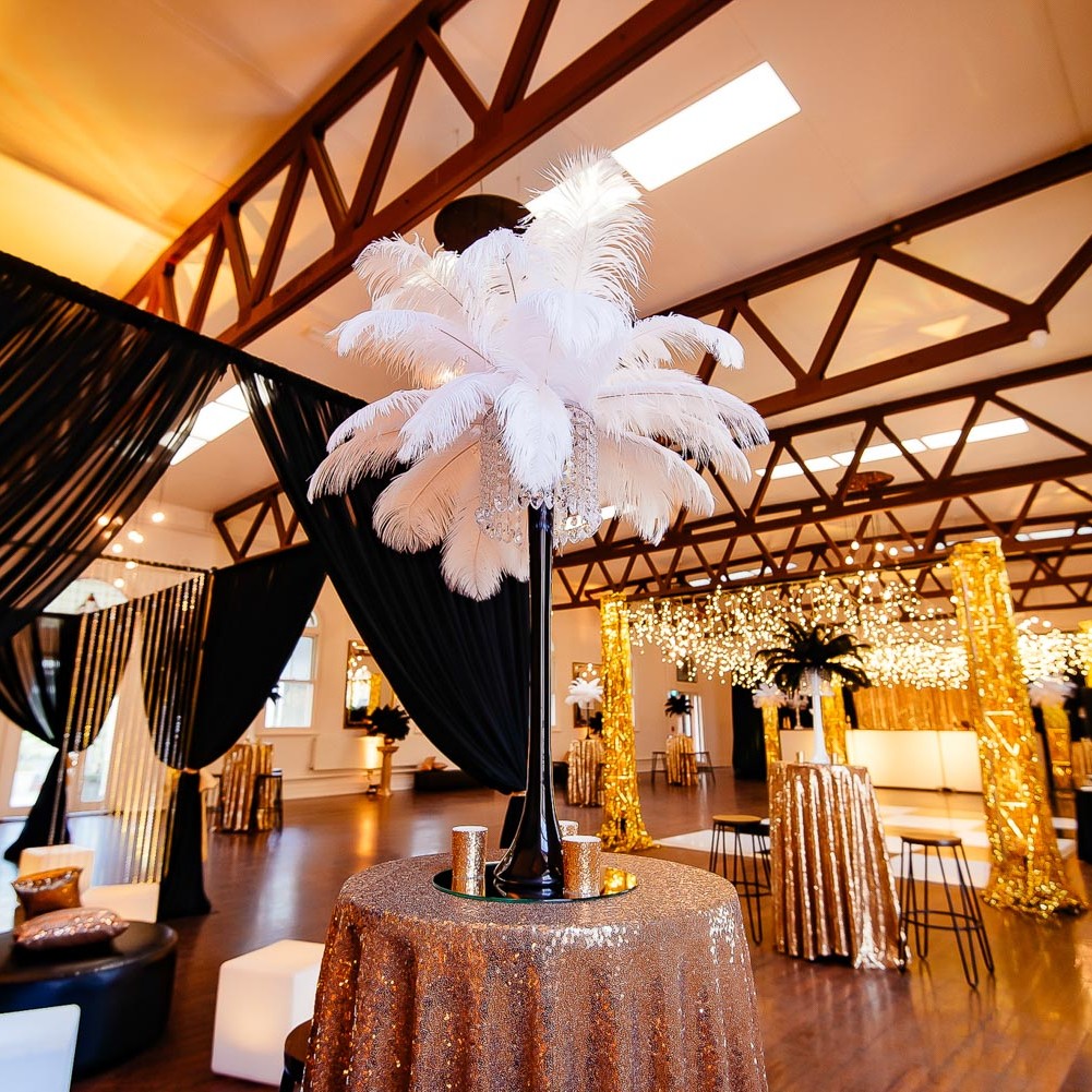 1920s themed bar furniture and feather centrepieces setup