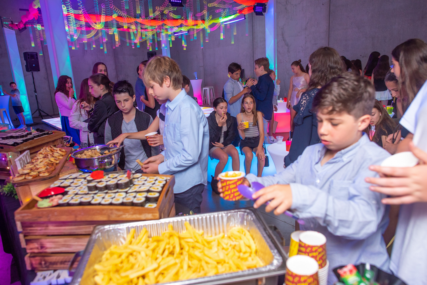 glow themed bat mitzvah food station with dance floor in background