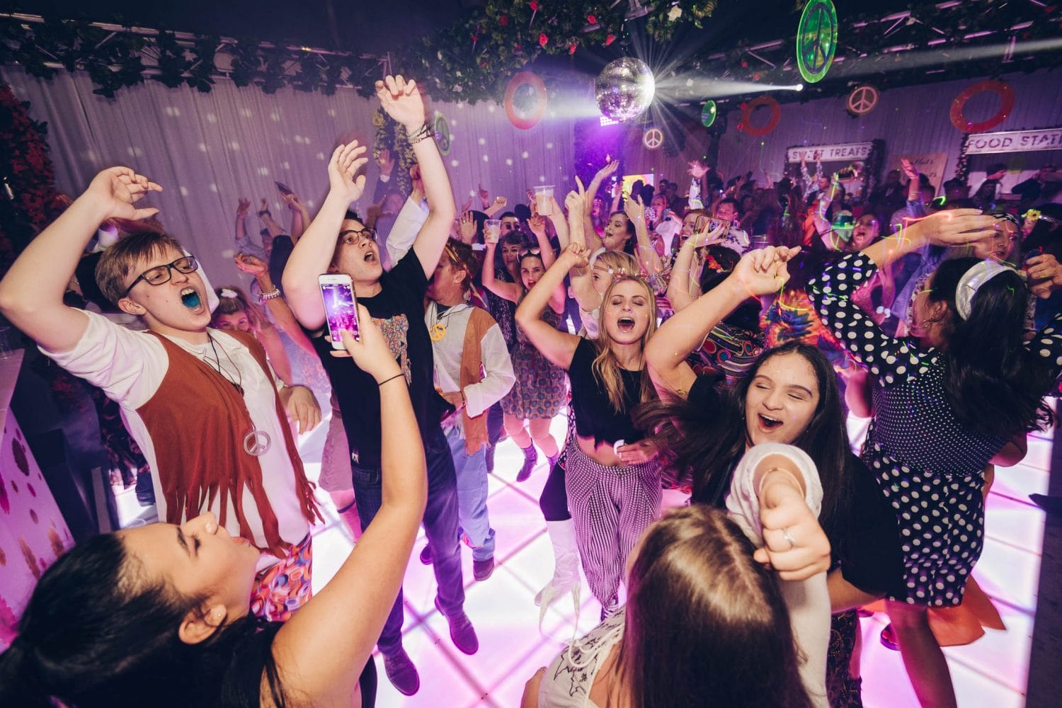 people dancing at 60s themed party