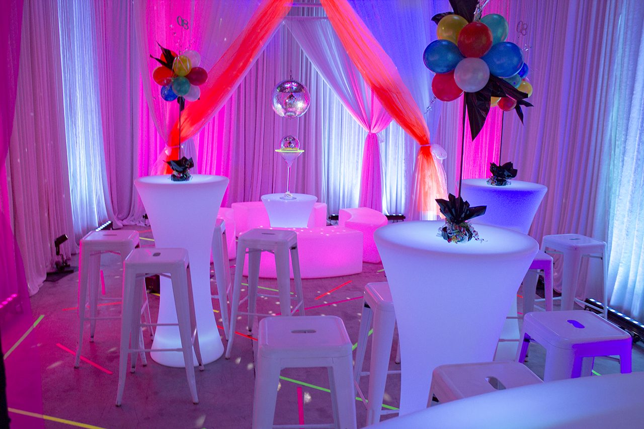 80s themed event illuminated bar tables and white stools