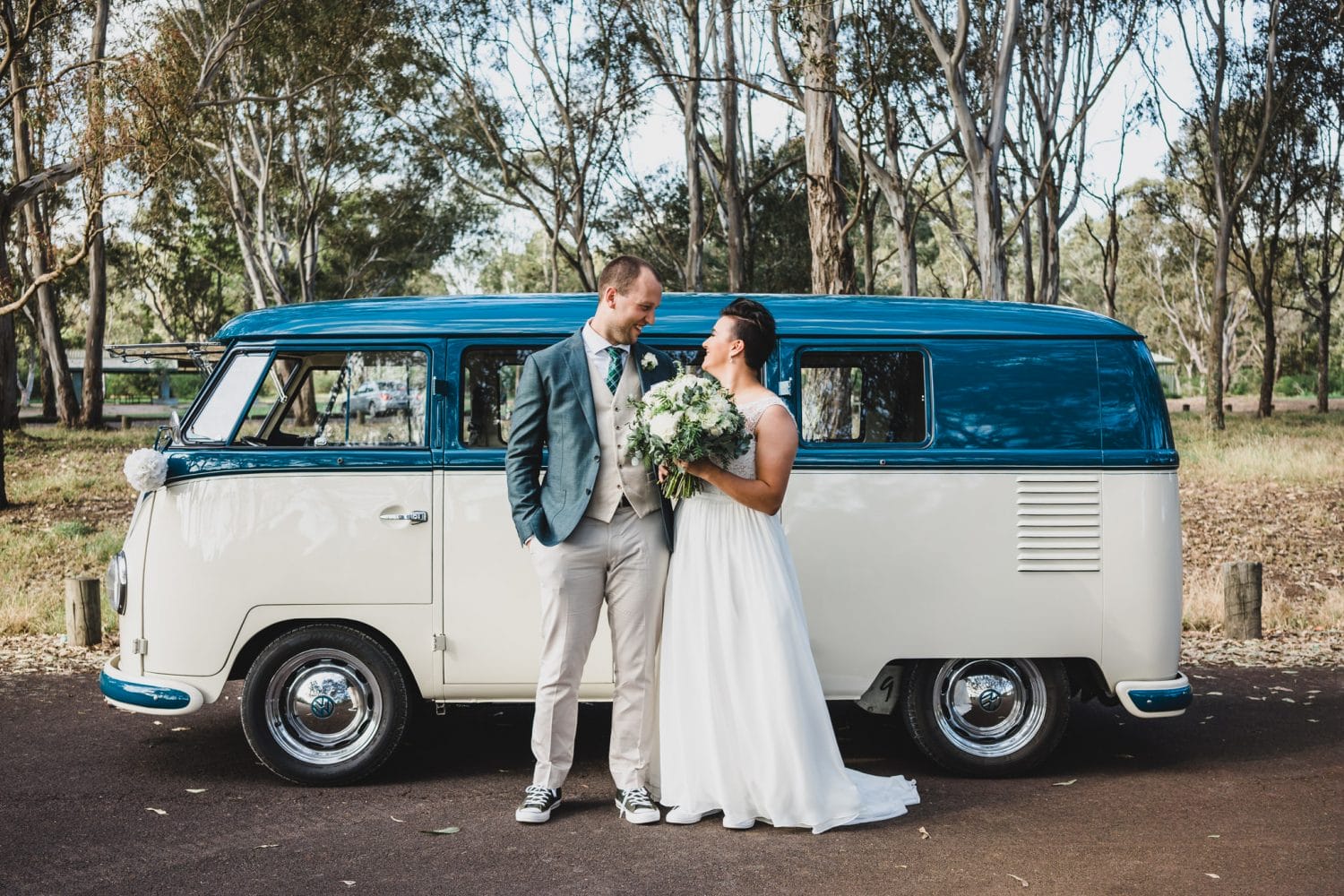 wedding couple in front of car