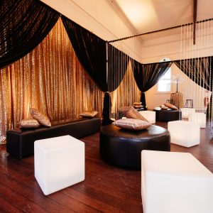 1920s themed lounge area black chiffon draping and ottomans