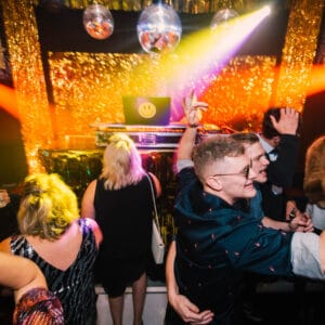 people dancing infront of a dj booth at studio 54 party