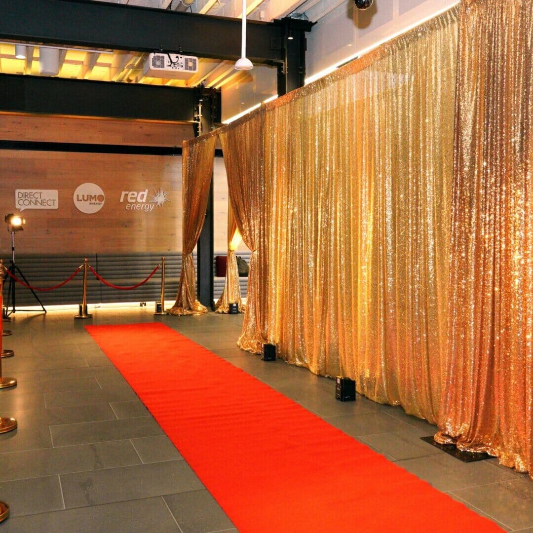 red carpet and gold sequin drape