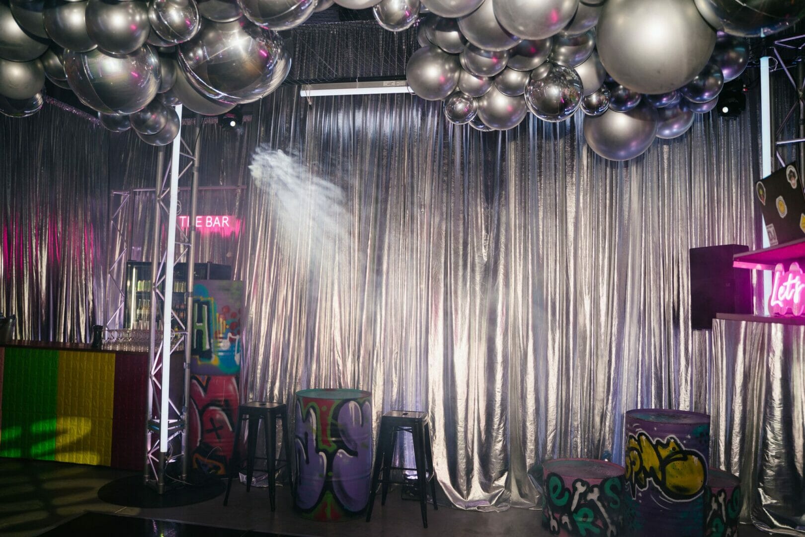 silver drape and balloon garland at graffiti themed party