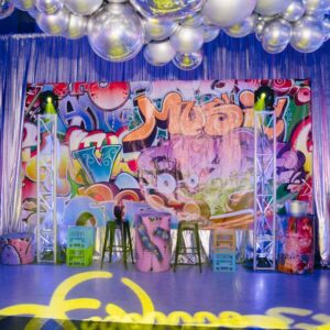 graffiti themed party themed backdrop, cocktail furniture, silver drape