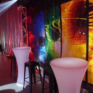 Space themed backdrop, led bar tables and black bar stools at space themed party