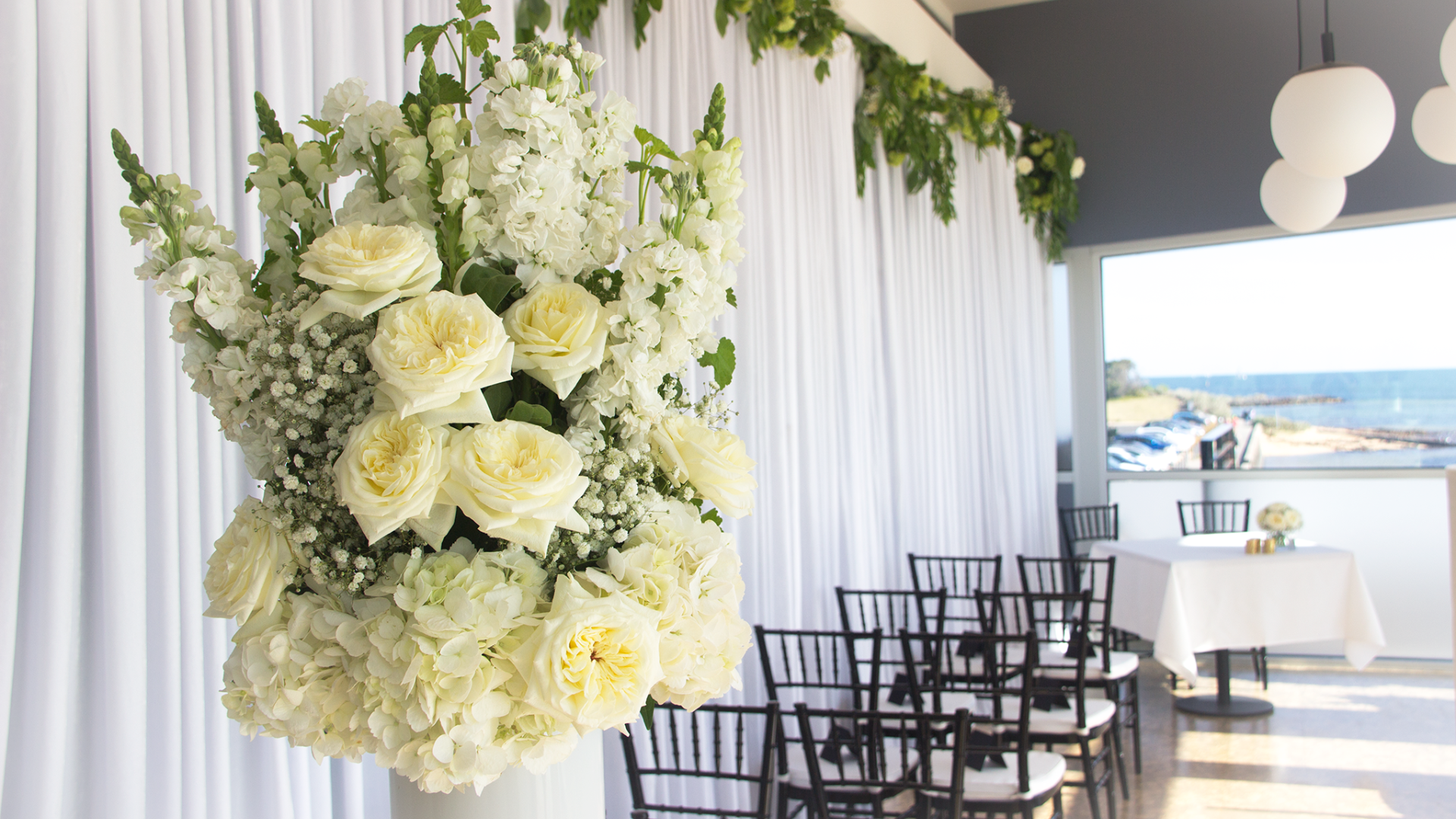 white floral arrangement by foxy evergreen for a wedding