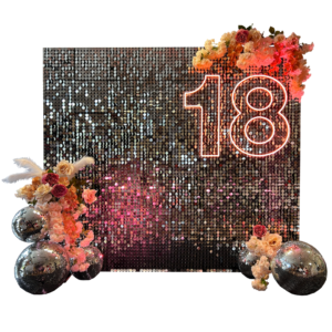 Peach and silver sequin backdrop with neon sign, florals, and mirror balls