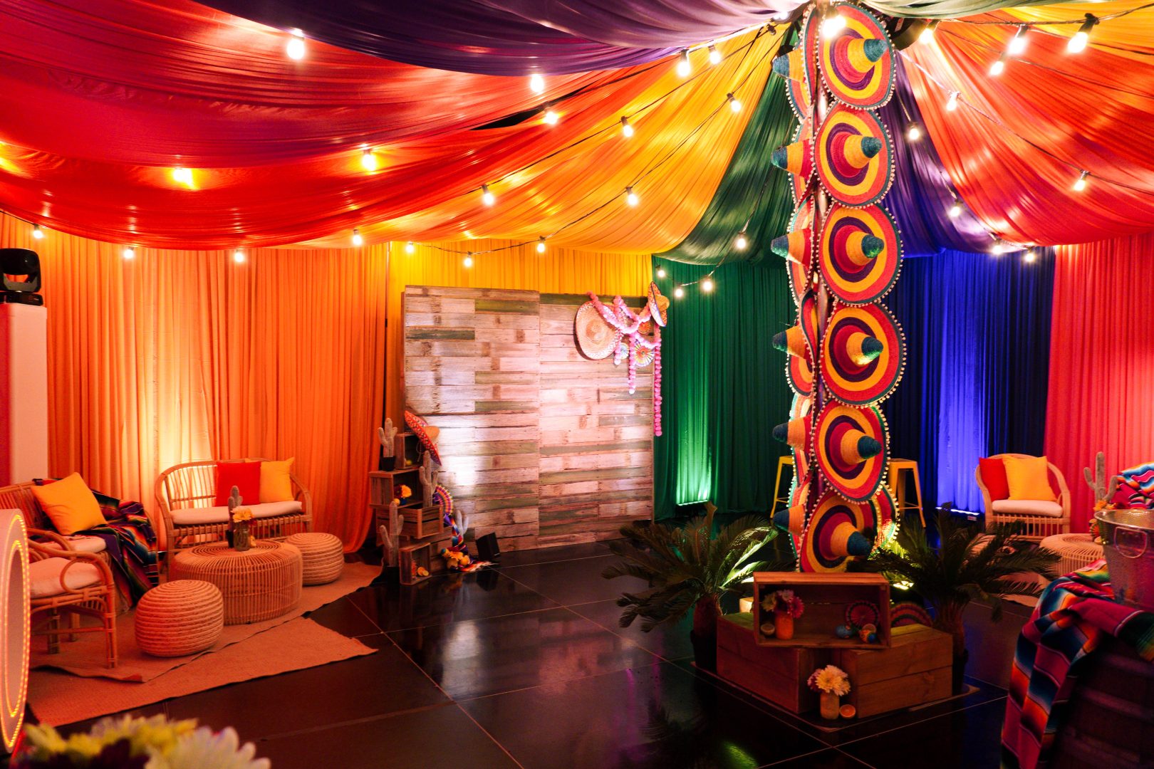 Colourful drape, rustic backdrop sombreros, festoon lights, artificial plants & flowers