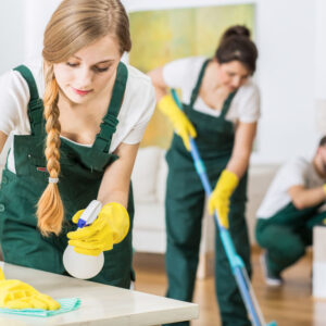 Professional cleaning service in uniforms during work