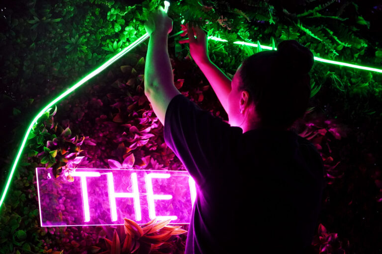 Team photo - emma setting up neon disco party
