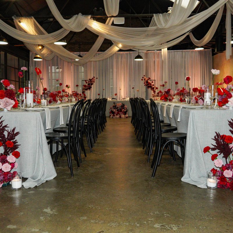 Red & pink wedding setup at rock art events Modern, elegant, wedding reception setup with red and pink florals
