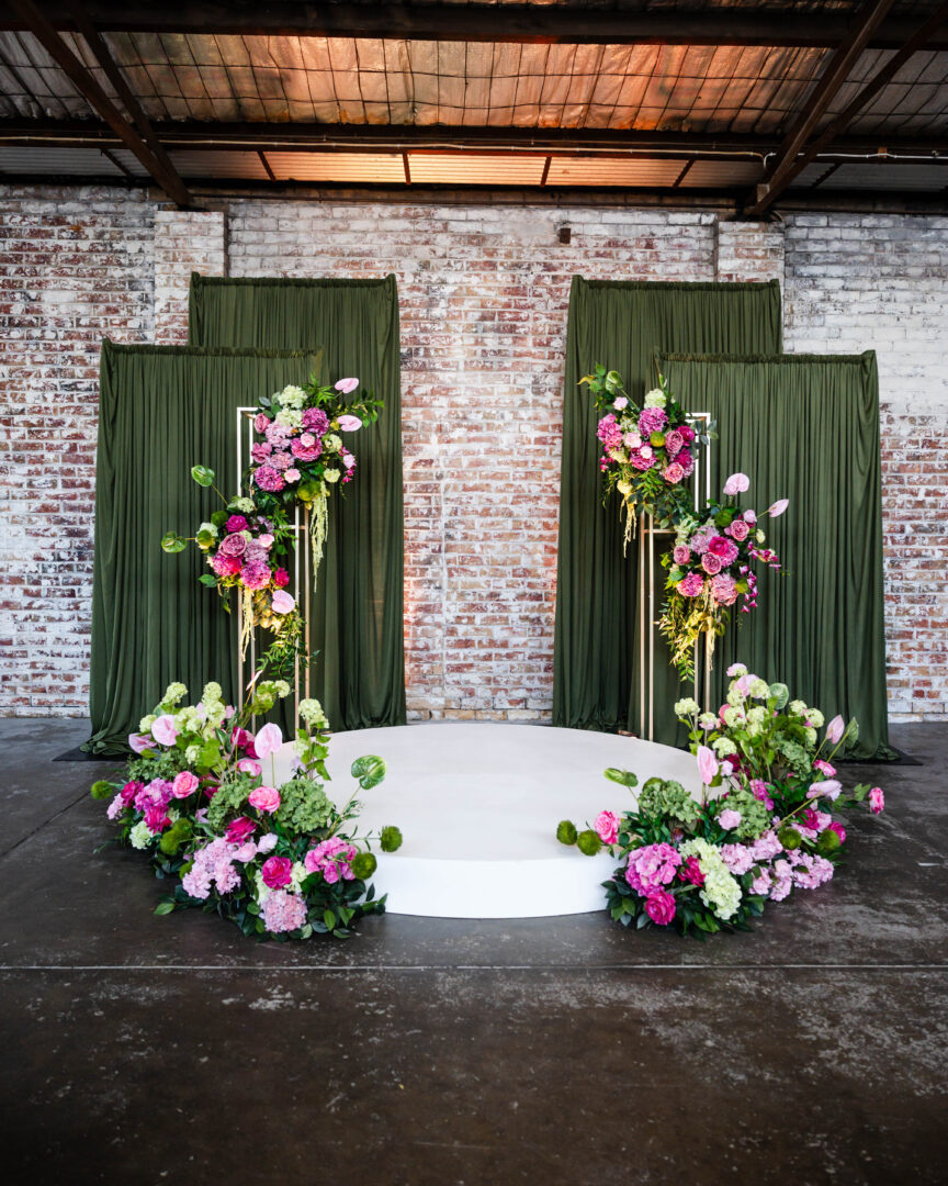 green draping wedding ceremony, wedding ceremony backdrop green drapes, greenery draped ceremony setup, elegant green fabric wedding styling, indoor wedding ceremony green draping, romantic green draped aisle backdrop, wedding ceremony styling with greenery and draping, soft green fabric ceremony decor, modern green draping wedding design, lush greenery ceremony backdrop styling