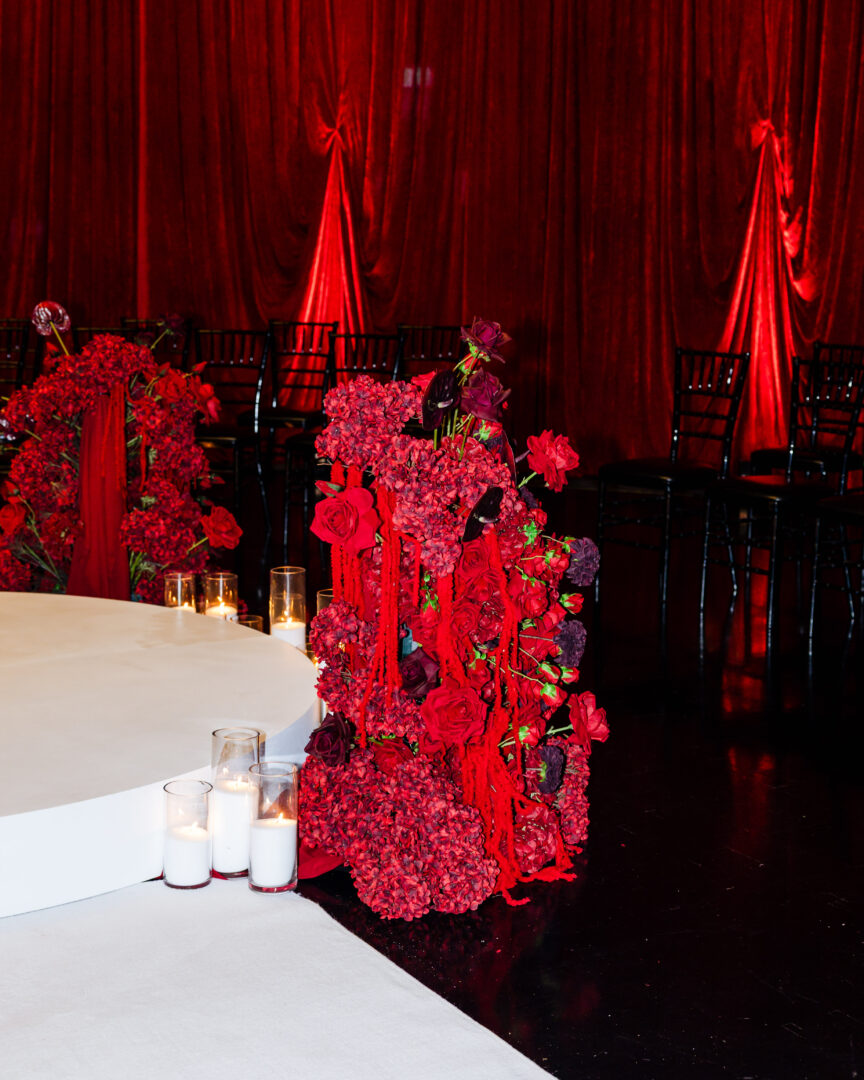 deep red wedding ceremony melbourne, red wedding ceremony styling, romantic red ceremony setup, moody wedding ceremony design, red draping wedding ceremony, velvet drape ceremony backdrop, candlelit wedding ceremony aisle, circular ceremony stage wedding, intimate wedding ceremony setup, luxury red wedding styling melbourne, dramatic wedding ceremony lighting, red floral ceremony installations, modern romantic wedding ceremony, immersive ceremony layout wedding, unique wedding ceremony design melbourne, aisle candles wedding ceremony, dark romantic wedding theme, red and black wedding styling, ceremony stage with florals and candles, statement wedding ceremony backdrop, wedding ceremony styling melbourne, high end wedding ceremony design, atmospheric ceremony lighting wedding, bold colour wedding ceremony, contemporary wedding ceremony setup