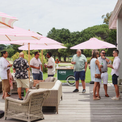 Guests mingling in the outdoor area of the CBRE end of year event corporate event planning timeline