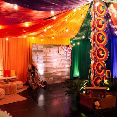 Colourful drape, rustic backdrop sombreros, festoon lights, artificial plants & flowers transforming 1 warehouse into 4 party themes mexican fiesta party theme
