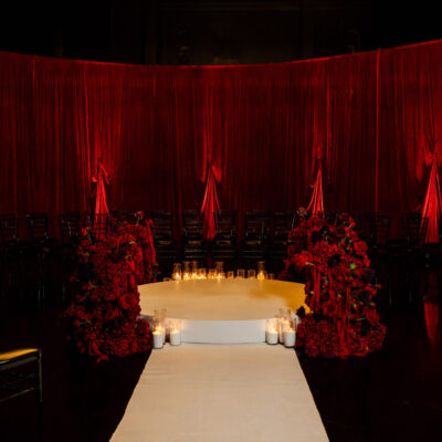 deep red wedding ceremony melbourne, red wedding ceremony styling, romantic red ceremony setup, moody wedding ceremony design, red draping wedding ceremony, velvet drape ceremony backdrop, candlelit wedding ceremony aisle, circular ceremony stage wedding, intimate wedding ceremony setup, luxury red wedding styling melbourne, dramatic wedding ceremony lighting, red floral ceremony installations, modern romantic wedding ceremony, immersive ceremony layout wedding, unique wedding ceremony design melbourne, aisle candles wedding ceremony, dark romantic wedding theme, red and black wedding styling, ceremony stage with florals and candles, statement wedding ceremony backdrop, wedding ceremony styling melbourne, high end wedding ceremony design, atmospheric ceremony lighting wedding, bold colour wedding ceremony, contemporary wedding ceremony setup